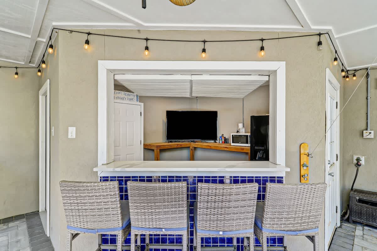 Your kitchen bar becomes the heart of your stay with warm string lights creating intimate ambiance for meals and conversations.