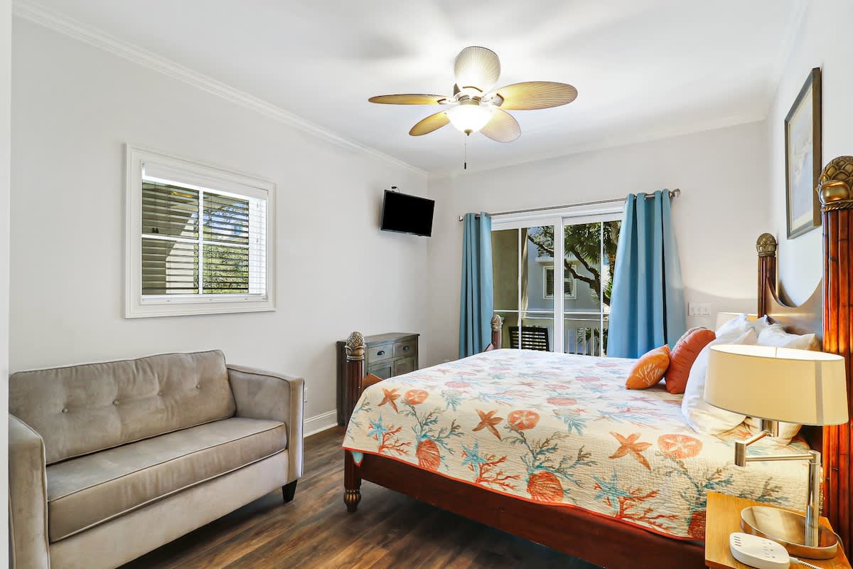 Wake up refreshed in your coastal-themed bedroom, complete with plush seating and a ceiling fan for perfect comfort.