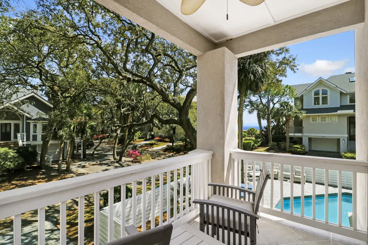 Your private balcony offers peaceful views of lush landscaping and sparkling pool, perfect for morning coffee or evening relaxation.