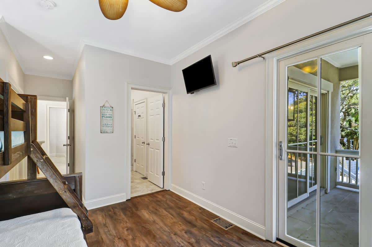 Bright and airy guest bedroom featuring a twin-over-full bunk bed, with balcony and Jack 'n Jill bathroom access.