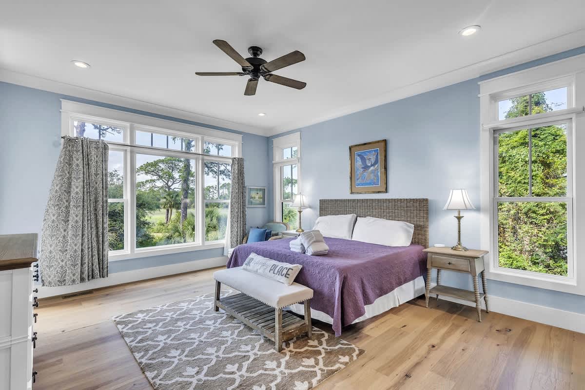 Main Floor Primary Suite with King Bed, En-Suite Bathroom, and Balcony Access