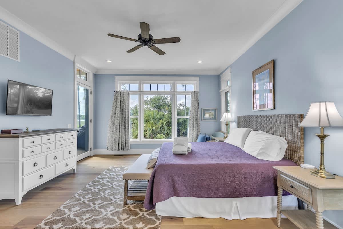Main Floor Primary Suite with King Bed, En-Suite Bathroom, and Balcony Access