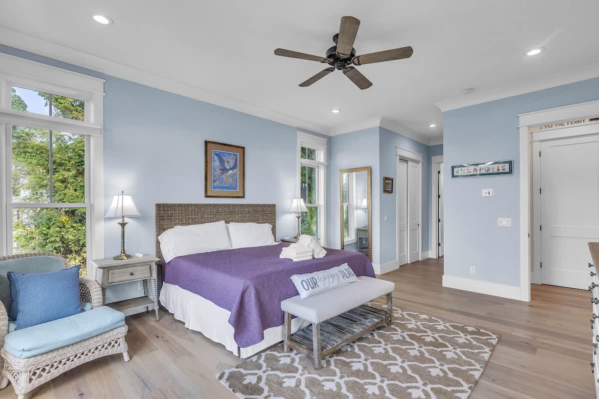 Main Floor Primary Suite with King Bed, En-Suite Bathroom, and Balcony Access