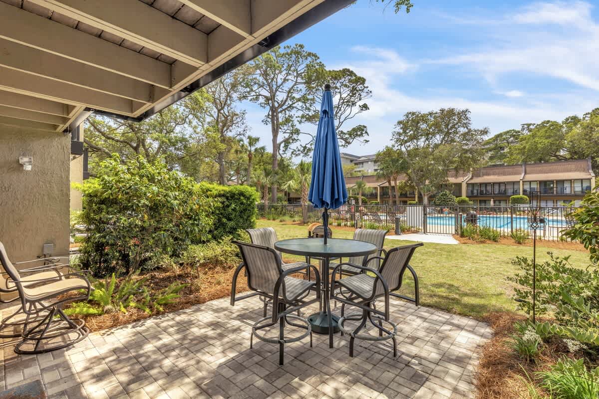 Private Patio Overlooking Community Pool with Charcoal Grill and Beach Path