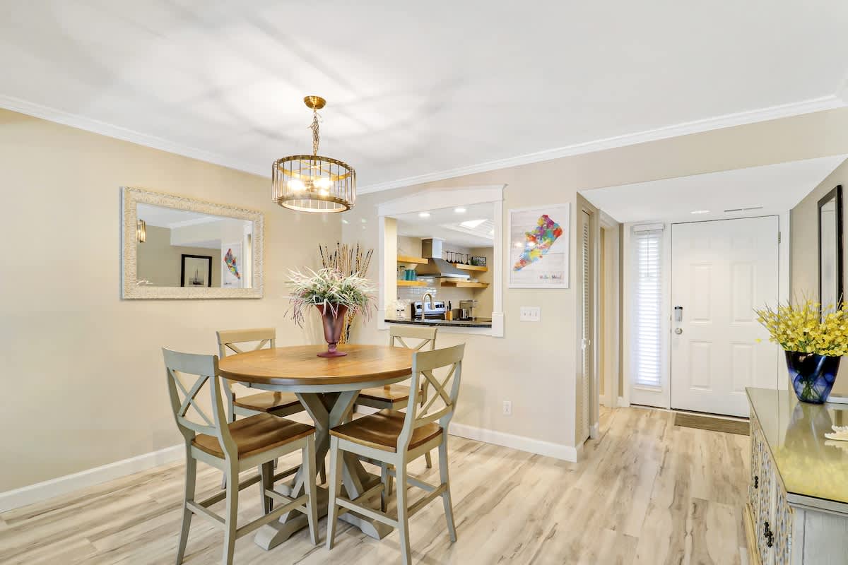 Your elegant dining space features a beautiful round table beneath a stunning chandelier, perfect for memorable meals.