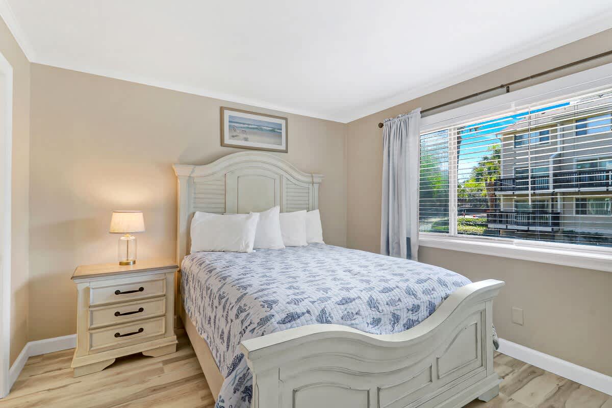 Rest peacefully in this serene bedroom featuring a cozy bed with soft linens and gentle natural light streaming through.