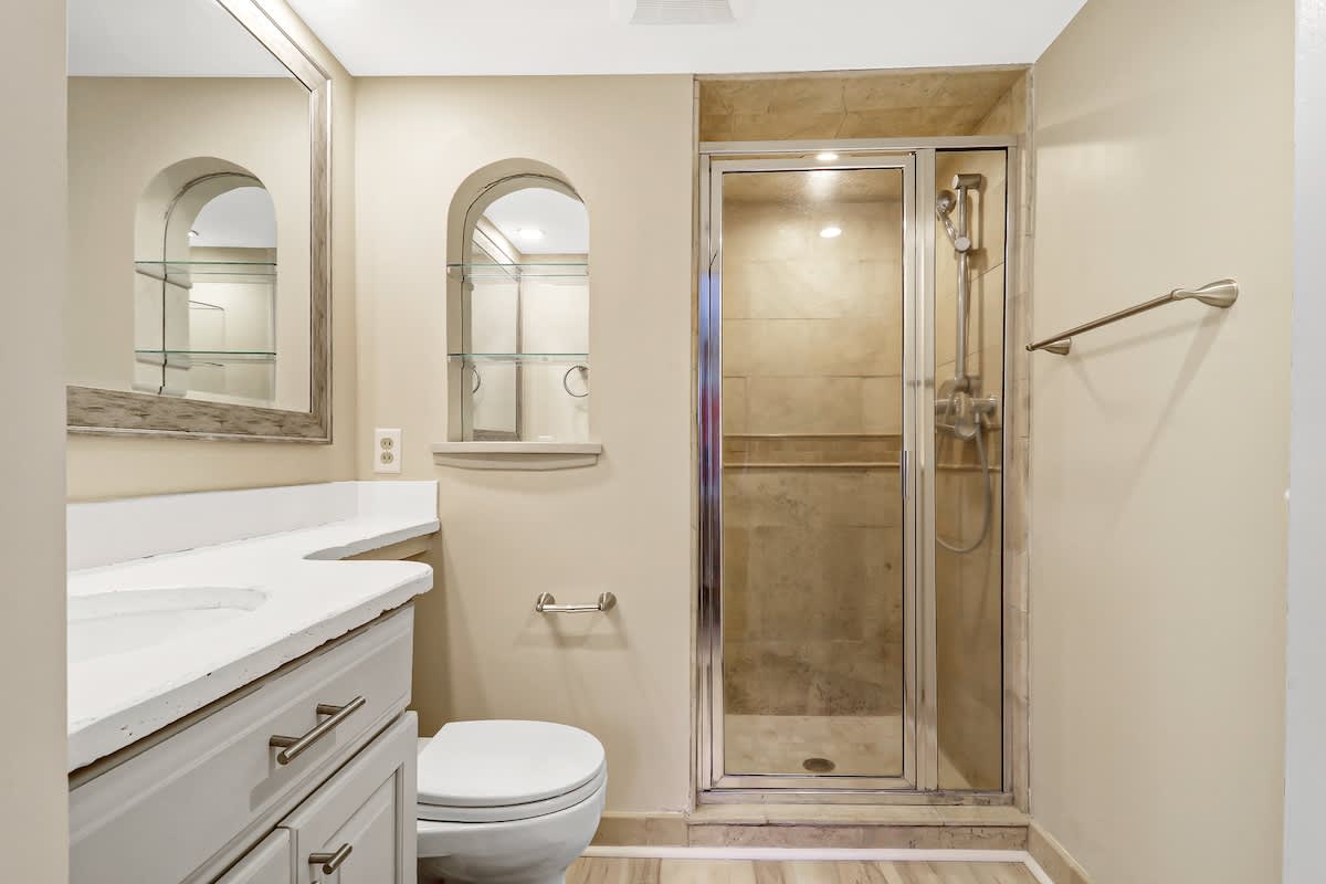 The primary bathroom features a spacious glass shower and thoughtful touches that make your morning routine feel luxurious.