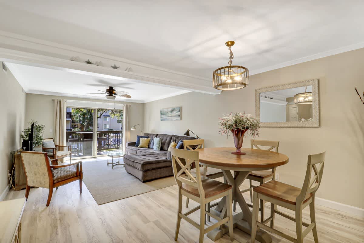 Gather around your elegant dining table while relaxing in the comfortable living room, where natural light flows through sliding doors to your private balcony.