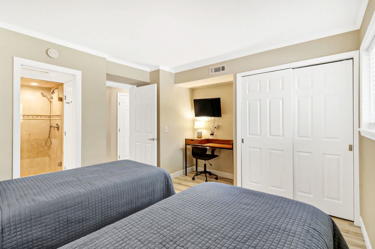 Sink into soft beds after freshening up in your private en-suite. The workspace keeps you connected while built-in storage holds all your belongings.