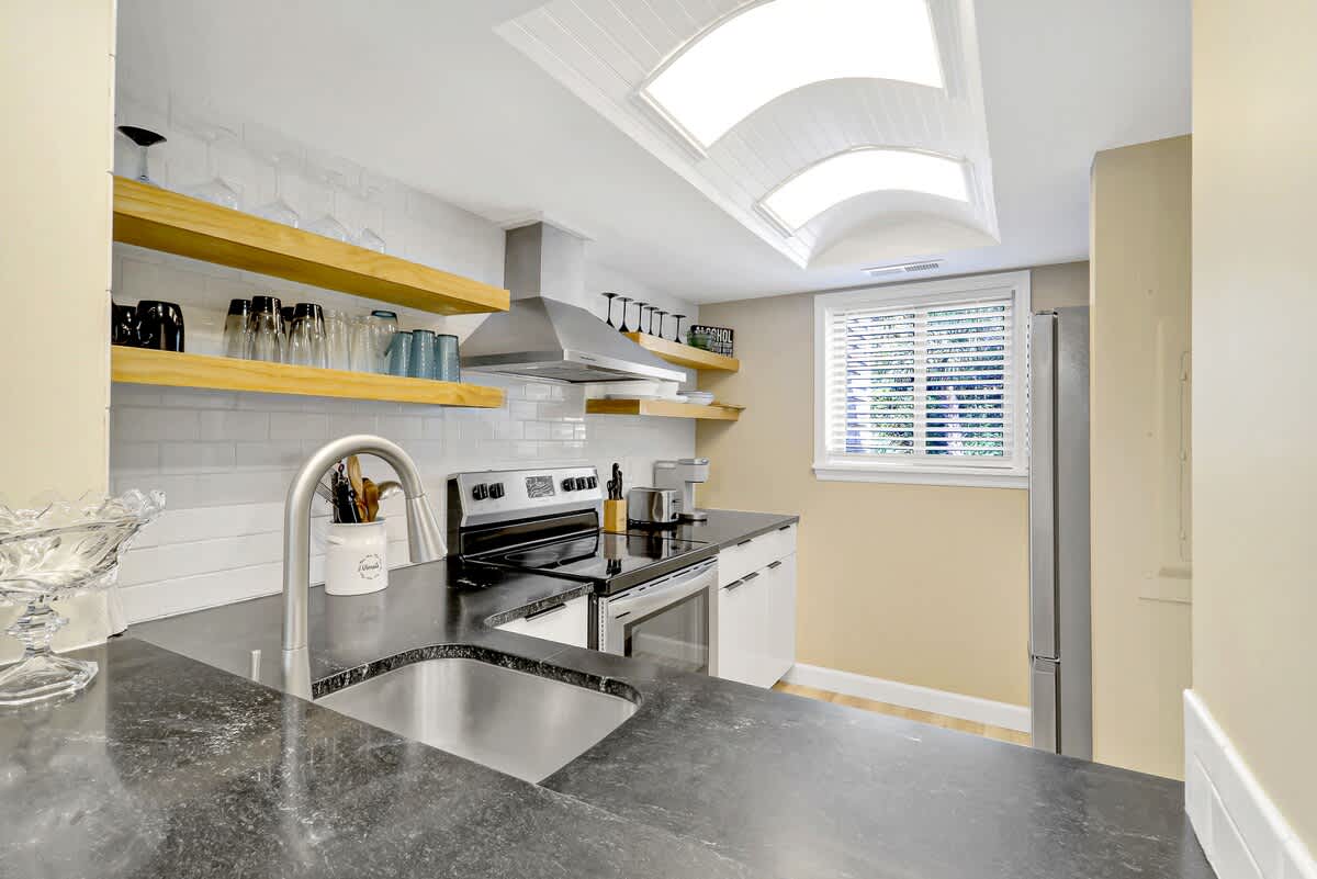 Your gourmet kitchen features sleek granite counters, modern appliances, and bright lights for cooking memorable meals.