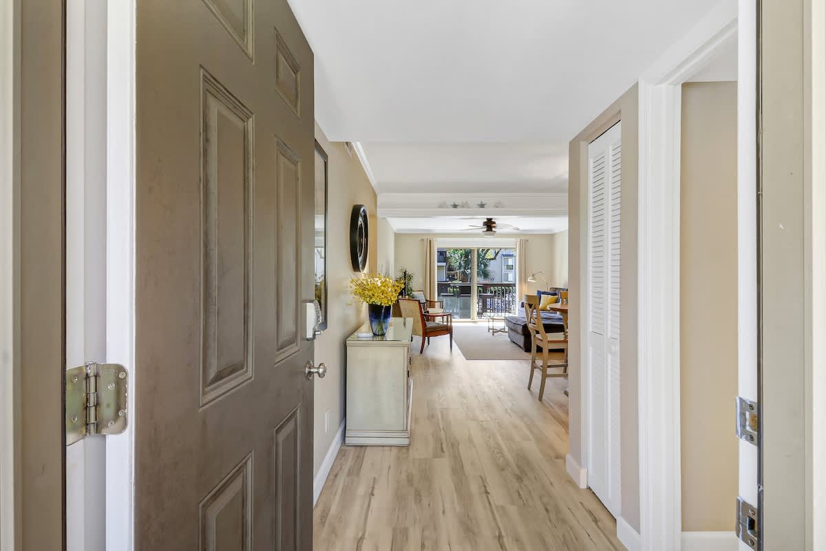 Step into your bright, welcoming space where warm wood floors flow through thoughtfully designed rooms filled with natural light.