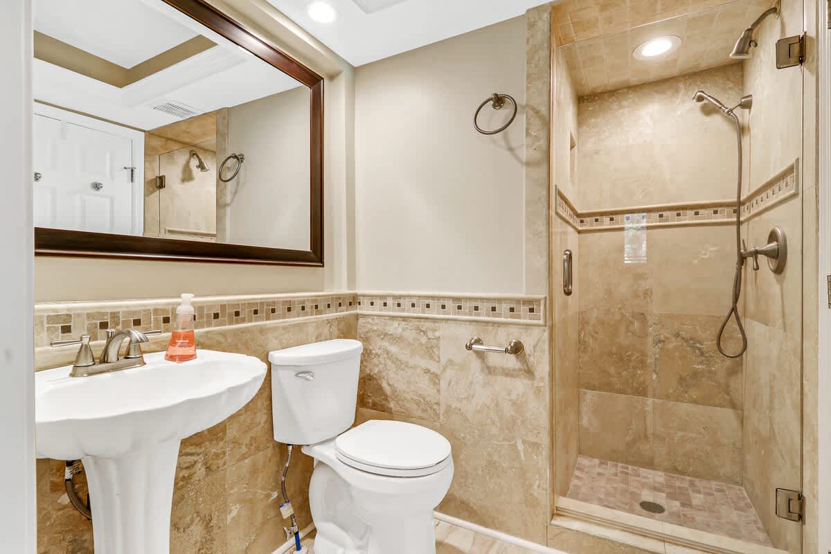 Refresh in your bathroom featuring a spacious walk-in shower and beautiful mosaic accent tiles.