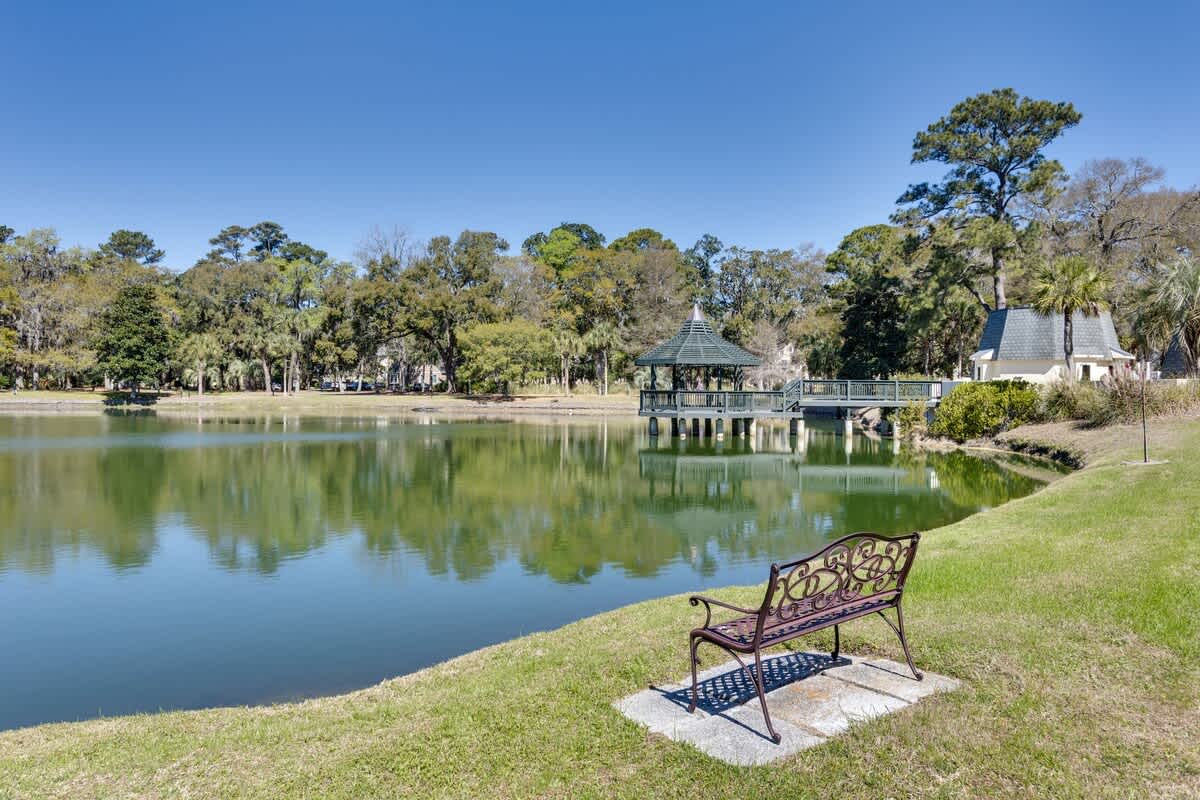 Peaceful lakeside park with gazebo and walking paths creates a serene neighborhood setting near the property.