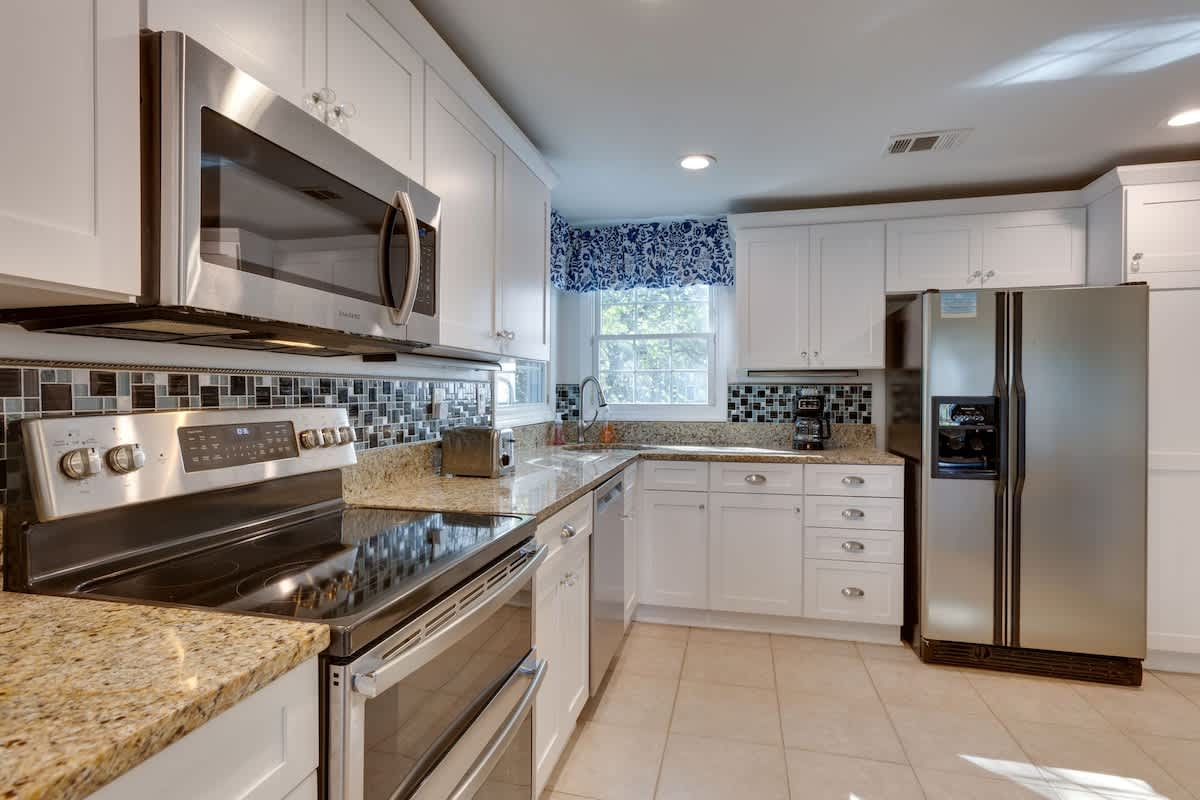 Your fully equipped kitchen features granite counters, stainless appliances, and abundant storage for creating memorable vacation meals together.