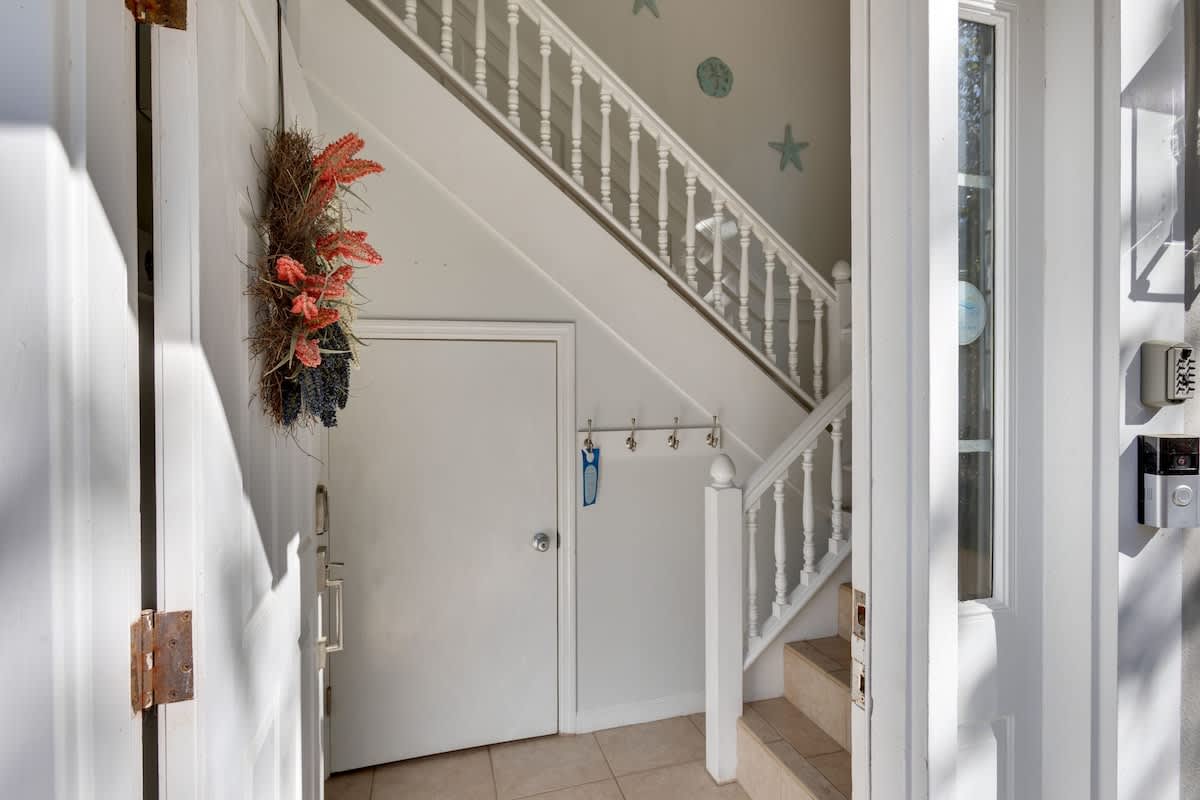 Step into your coastal retreat's bright entryway, where charming nautical touches and natural light create an instantly welcoming atmosphere.