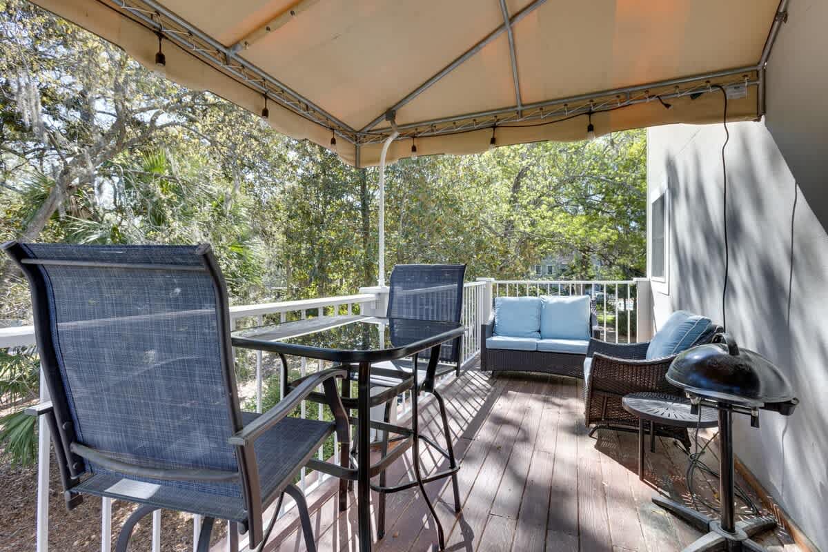 Unwind on your private covered balcony with comfortable seating and peaceful treetop views—perfect for morning coffee or evening relaxation.