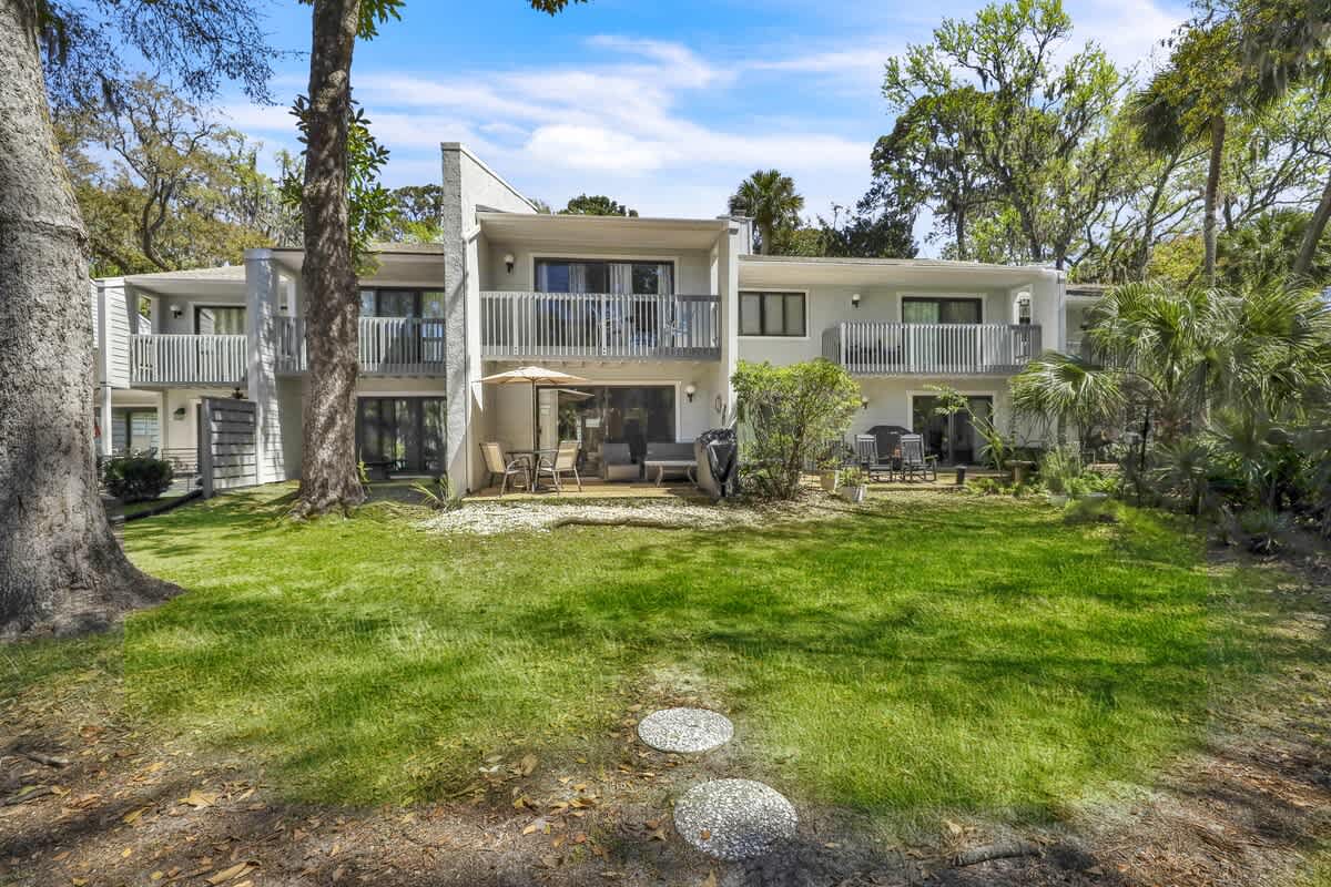Back Exterior of Home with Private Patio and Lagoon Views