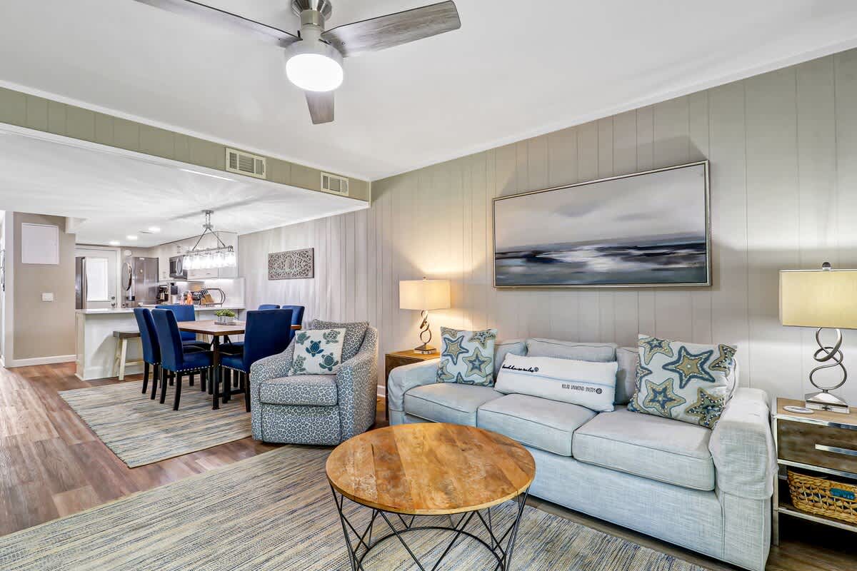 Unwind in your spacious living room with coastal charm, featuring plush seating and an open layout perfect for relaxing after your adventures.
