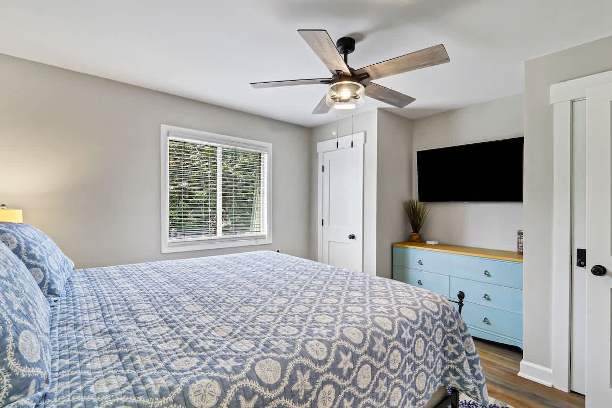 Wake up refreshed in your serene bedroom, where soft morning light streams through windows and gentle ceiling fan keeps you cool.