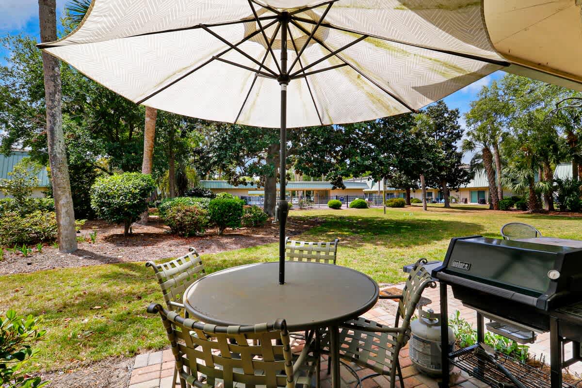 Your private patio offers shaded dining and BBQ facilities, perfect for outdoor meals surrounded by lush tropical gardens.