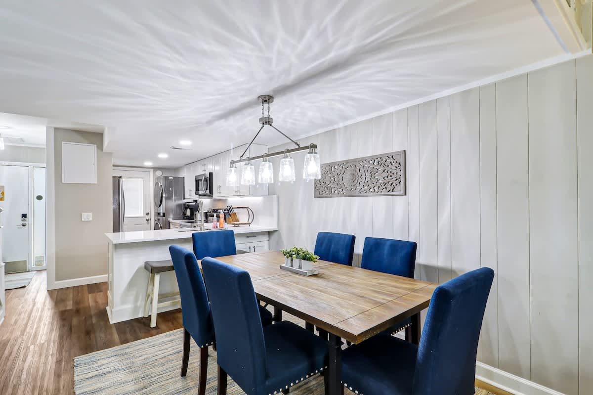 Memorable meals unfold beneath stylish lighting in this open-concept space.