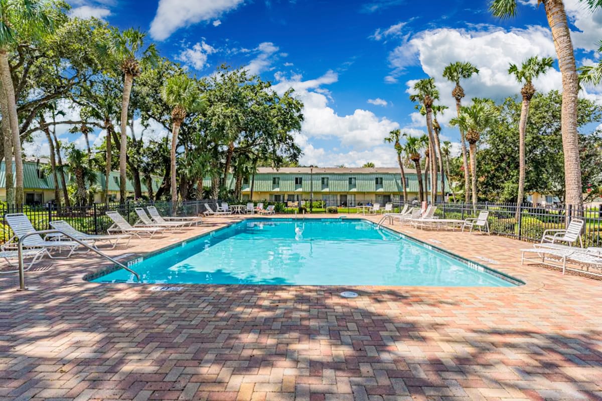 Take a refreshing dip in the sparkling pool surrounded by tropical palms and comfortable loungers for ultimate relaxation.