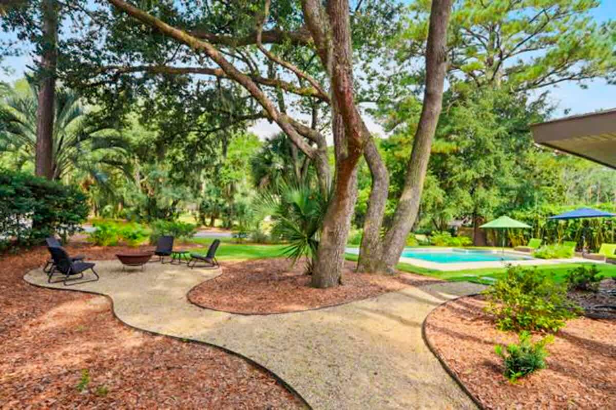 Backyard Pool and separate fire pit area, set beneath mature trees for shade and privacy