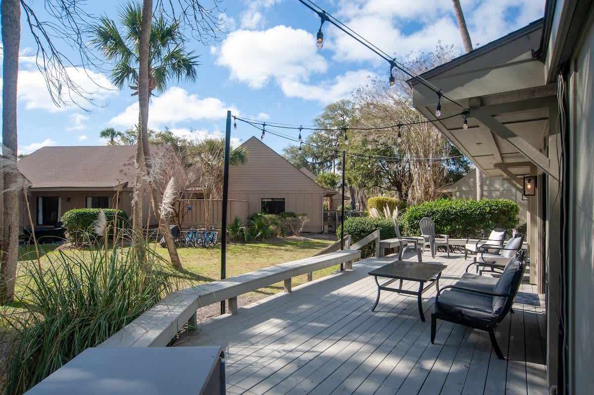 Unwind on your private deck with comfortable seating and string lights creating the perfect ambiance for evening relaxation.
