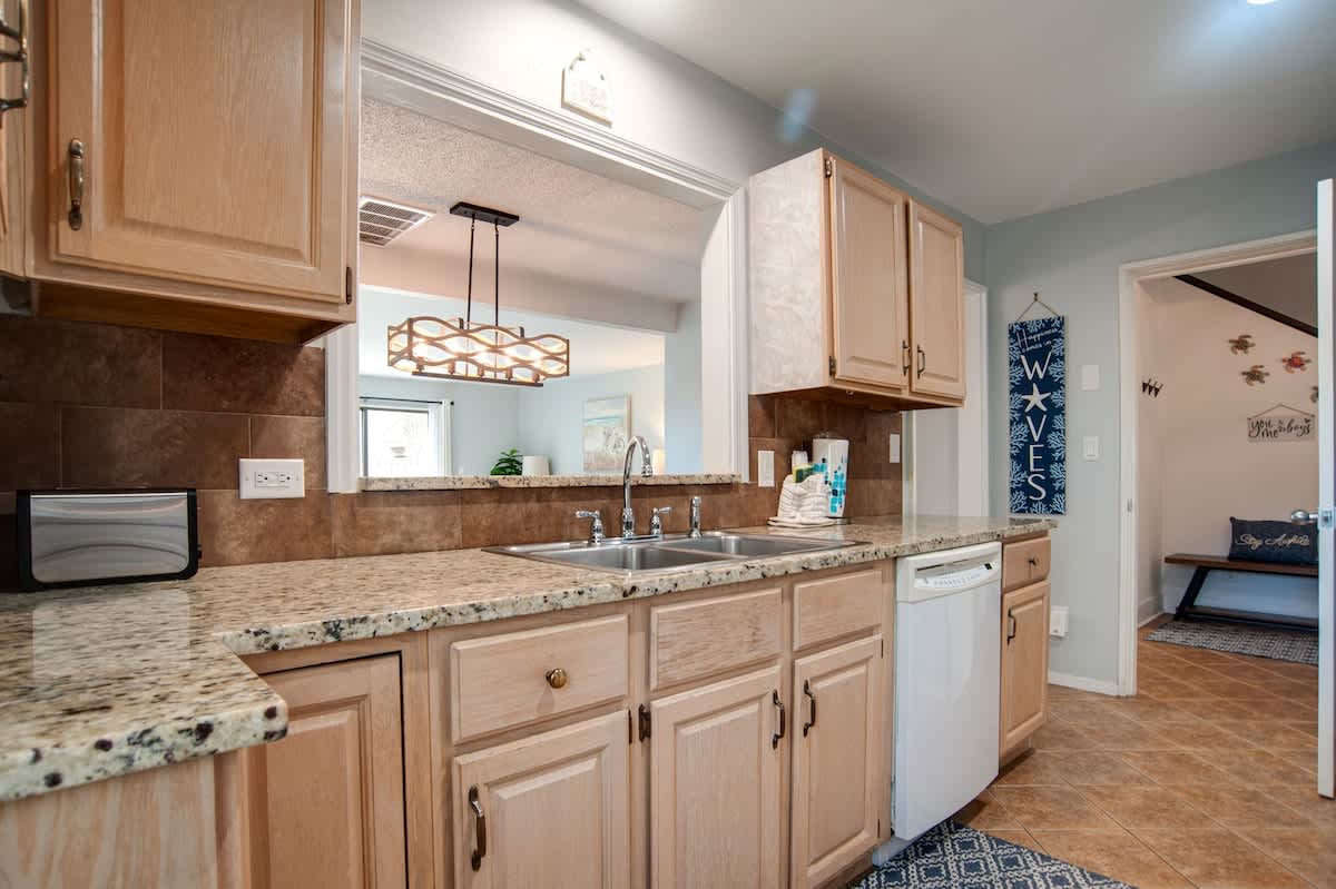 Step into your fully equipped kitchen with granite countertops and modern appliances, perfect for preparing memorable meals during your stay.