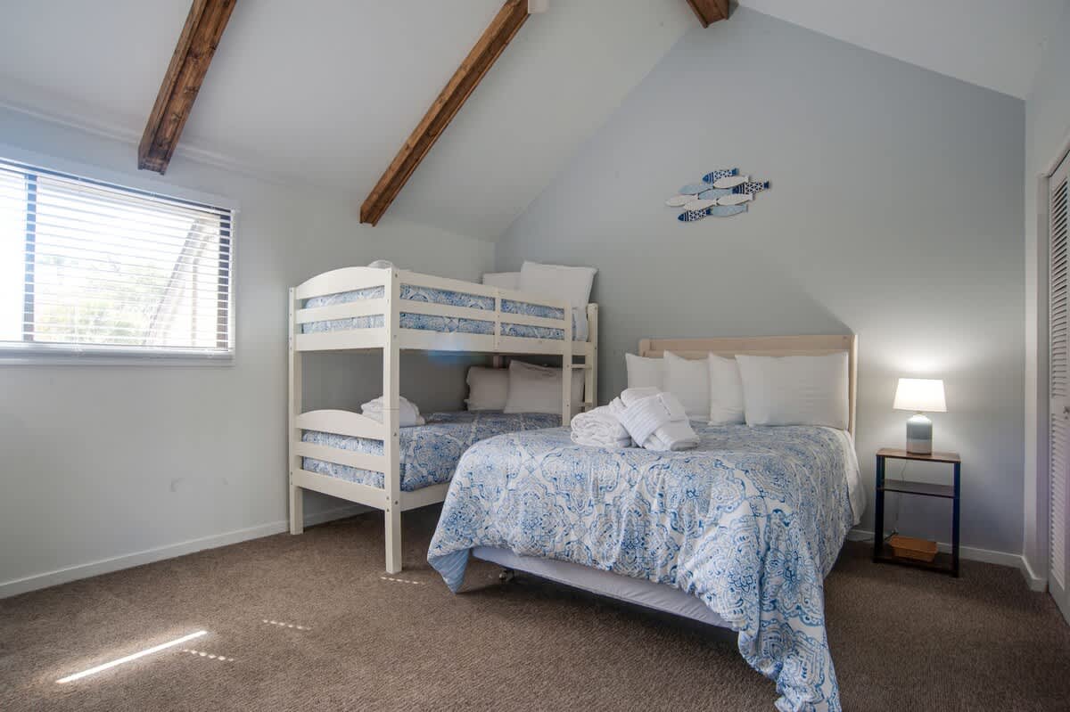 Drift off to sleep in your bright bedroom with exposed beams and cheerful blue linens. Perfect for families or friends sharing cozy memories.