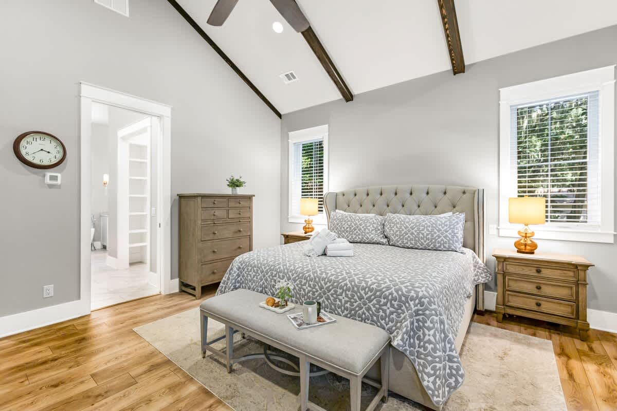Primary Suite on First Floor with King Bed, En-Suite Bathroom, and Access to Wraparound Porch