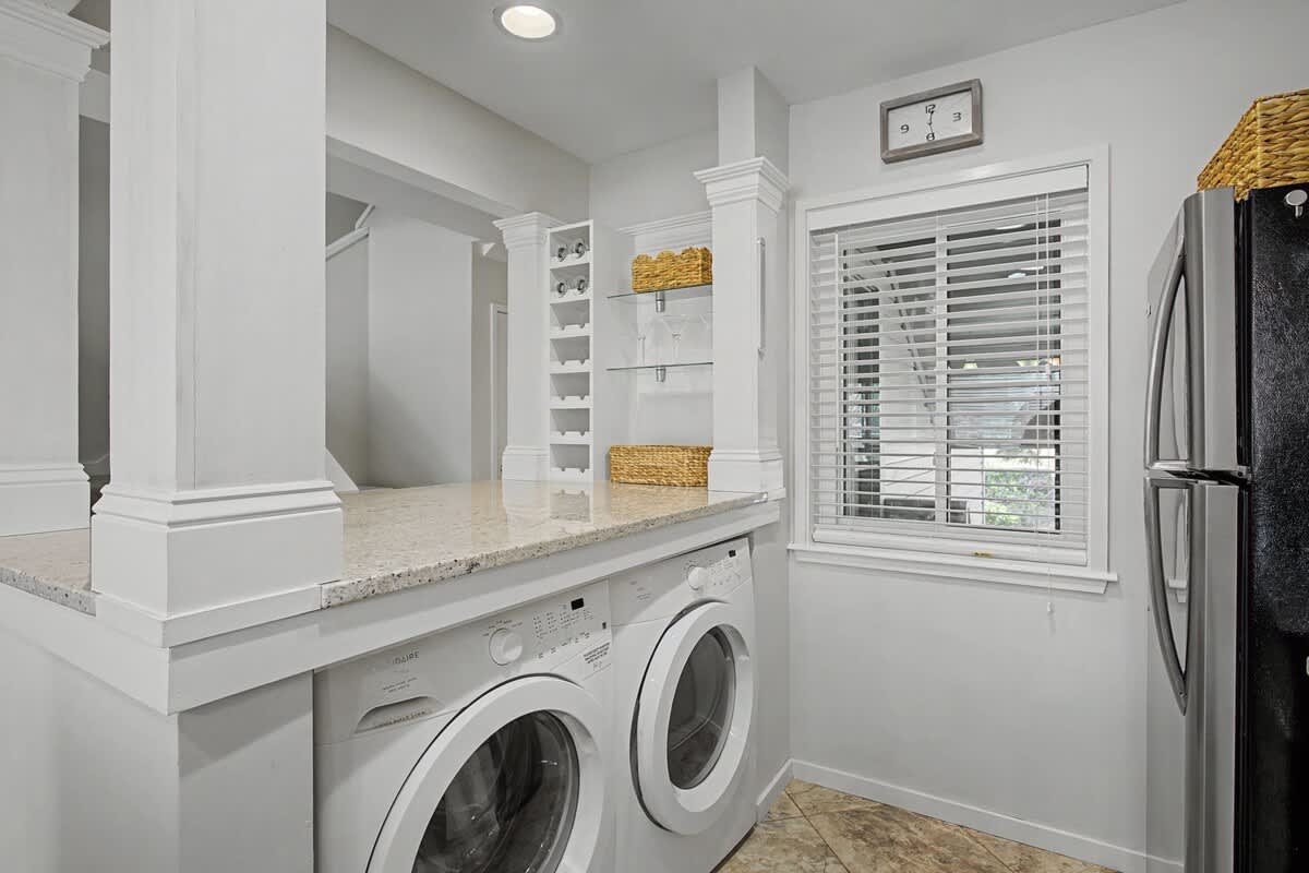 Your laundry day just got luxurious with this bright, organized space featuring modern appliances and ample storage.