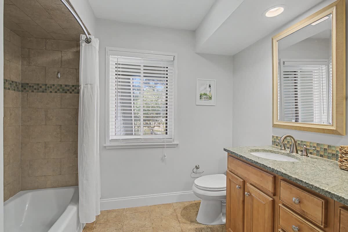 Unwind in your elegant bathroom featuring granite counters, tile shower, and natural light—perfect for your morning routine.