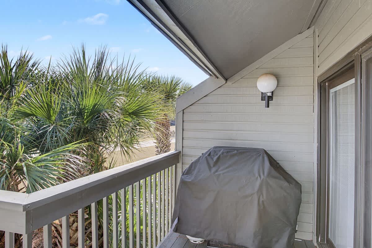 Your private covered balcony offers tropical palm views and a BBQ grill for seaside cooking adventures.