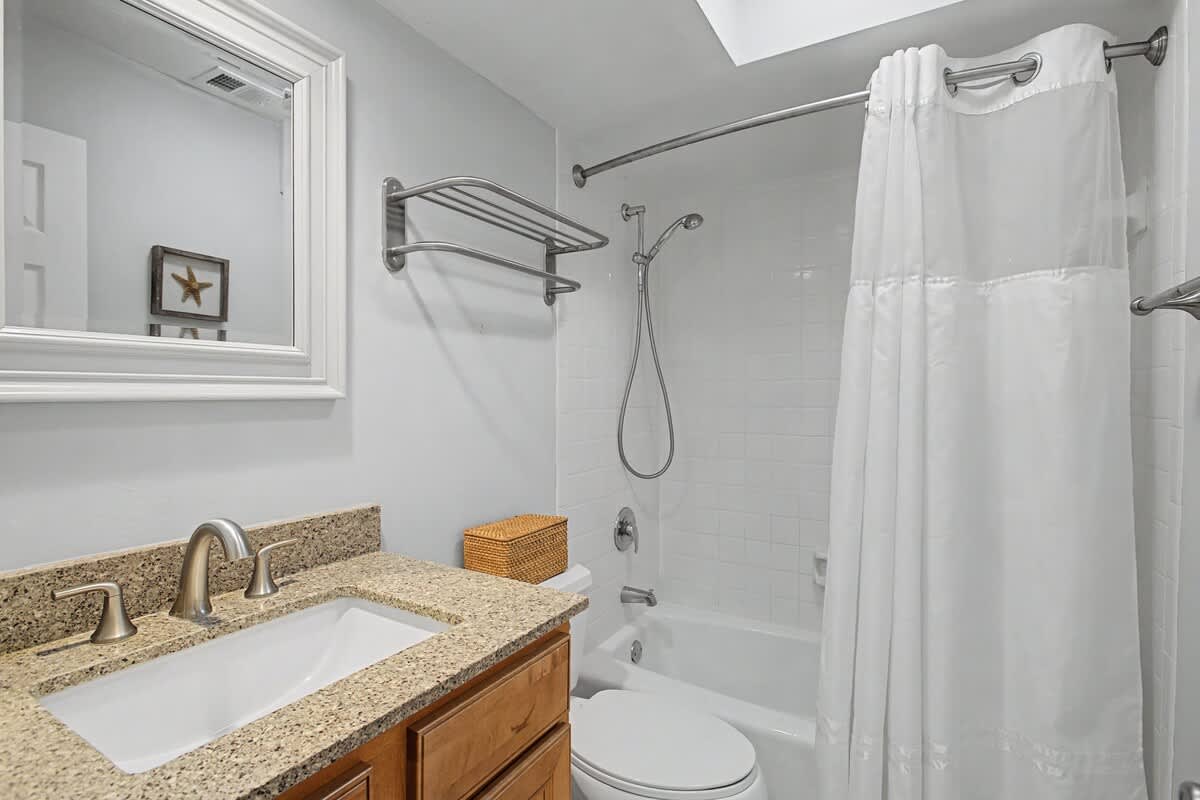 Refresh in your bright, clean bathroom with granite countertops, fresh towels, and a relaxing tub-shower combo.