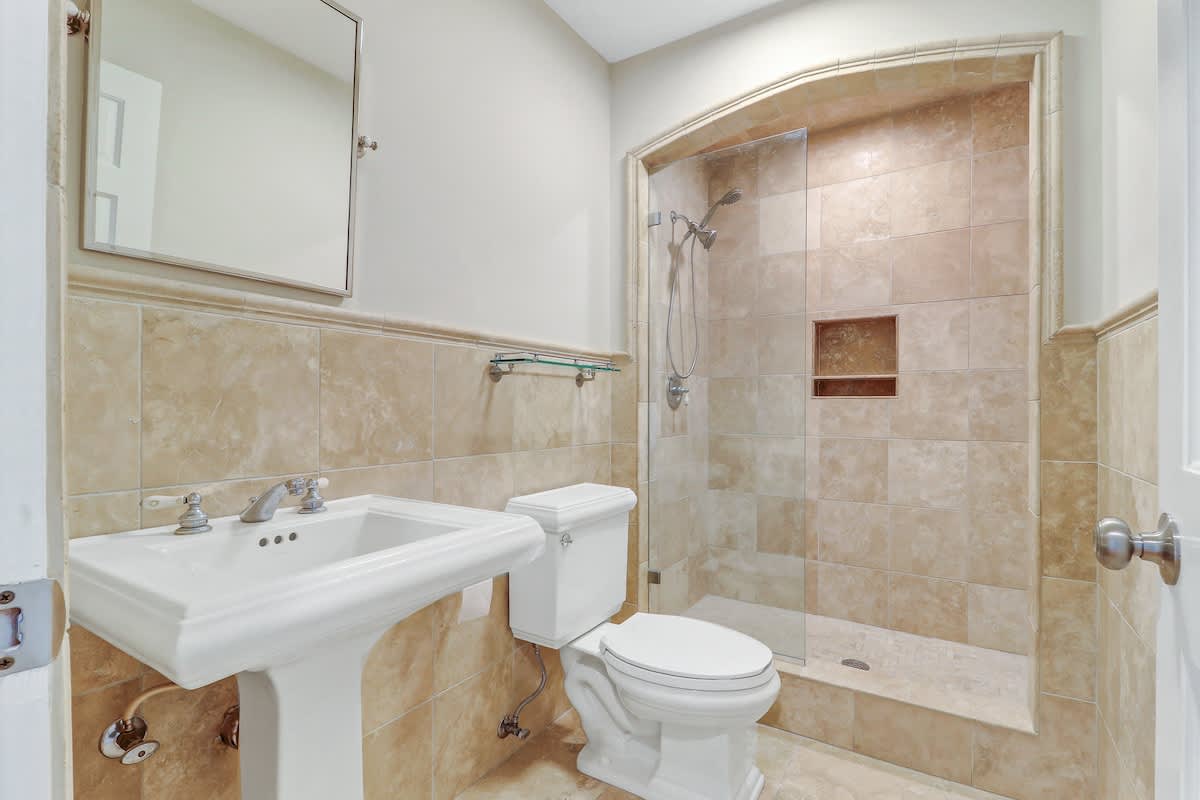 Refresh in your beautifully tiled bathroom with elegant fixtures and spacious walk-in shower.
