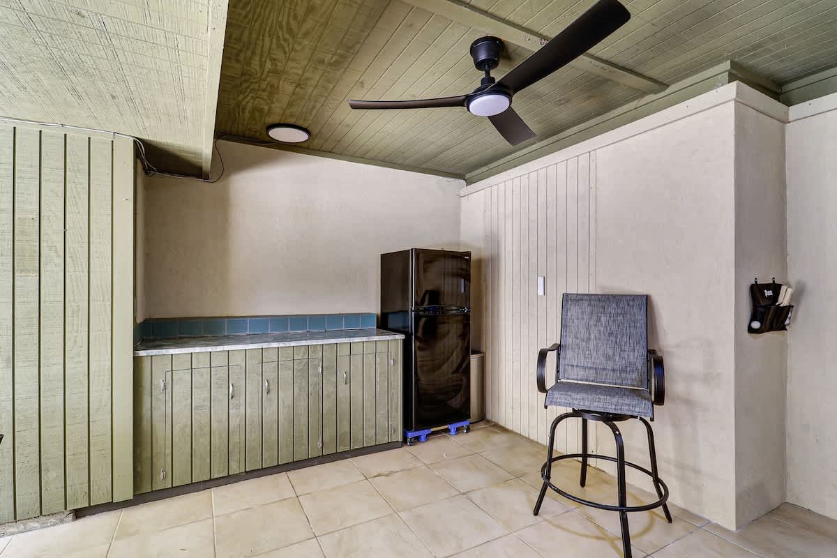 Convenient ground-level refreshment area, perfect for grabbing a cold drink and taking a break between poolside fun and outdoor games.