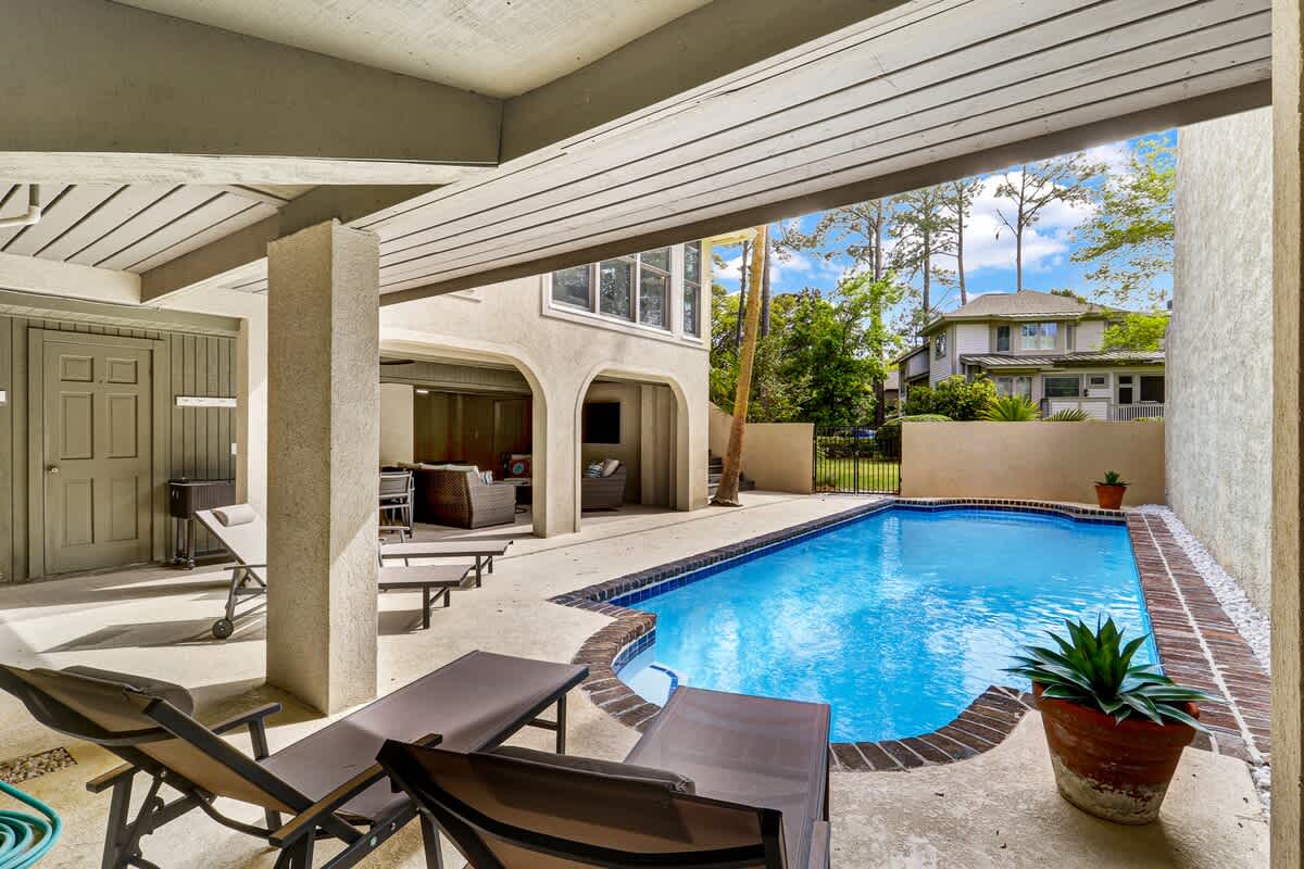 Your private pool oasis awaits, where you can lounge on comfortable chairs under the covered patio and take refreshing dips all day long.