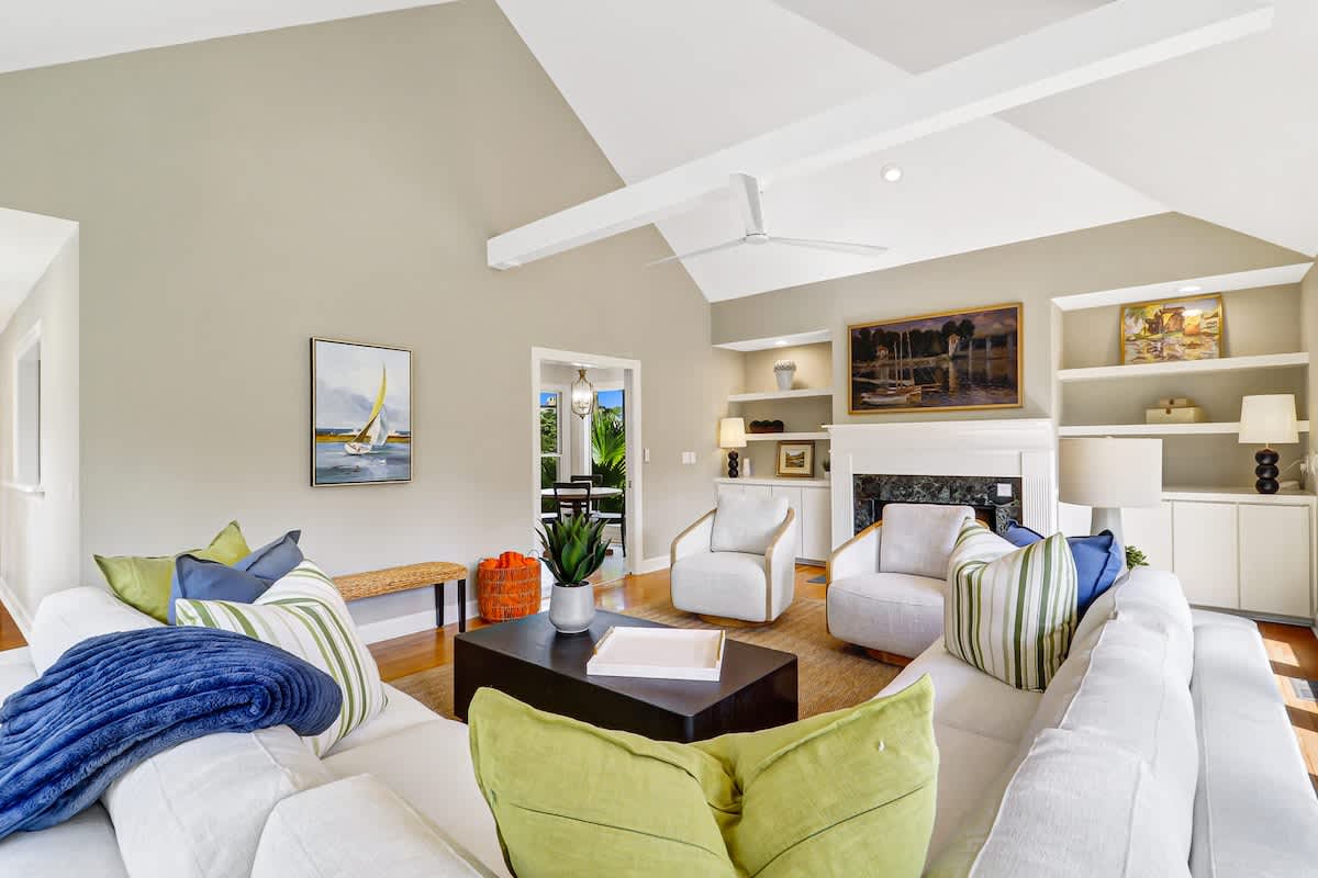 Relax in your spacious living room featuring vaulted ceilings, cozy fireplace, and comfortable seating perfect for gathering with loved ones.
