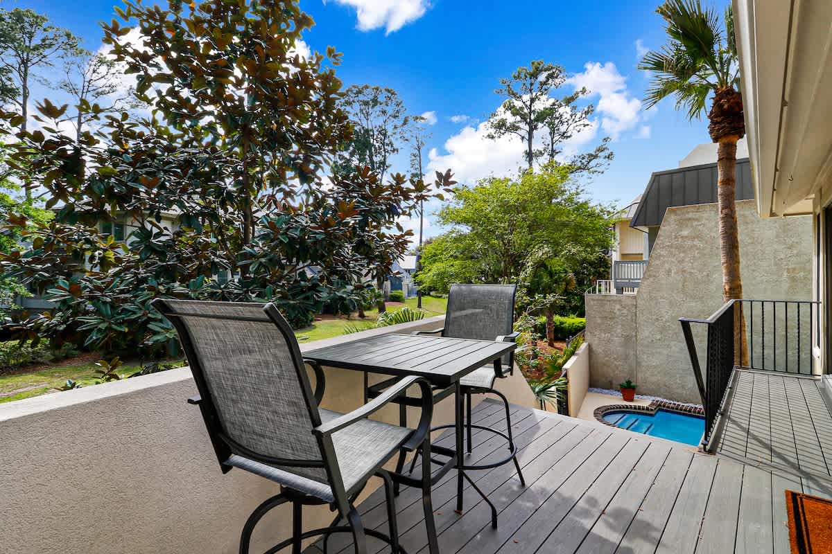 Your private deck overlooks lush gardens, where morning coffee tastes better surrounded by tropical greenery and peaceful views.