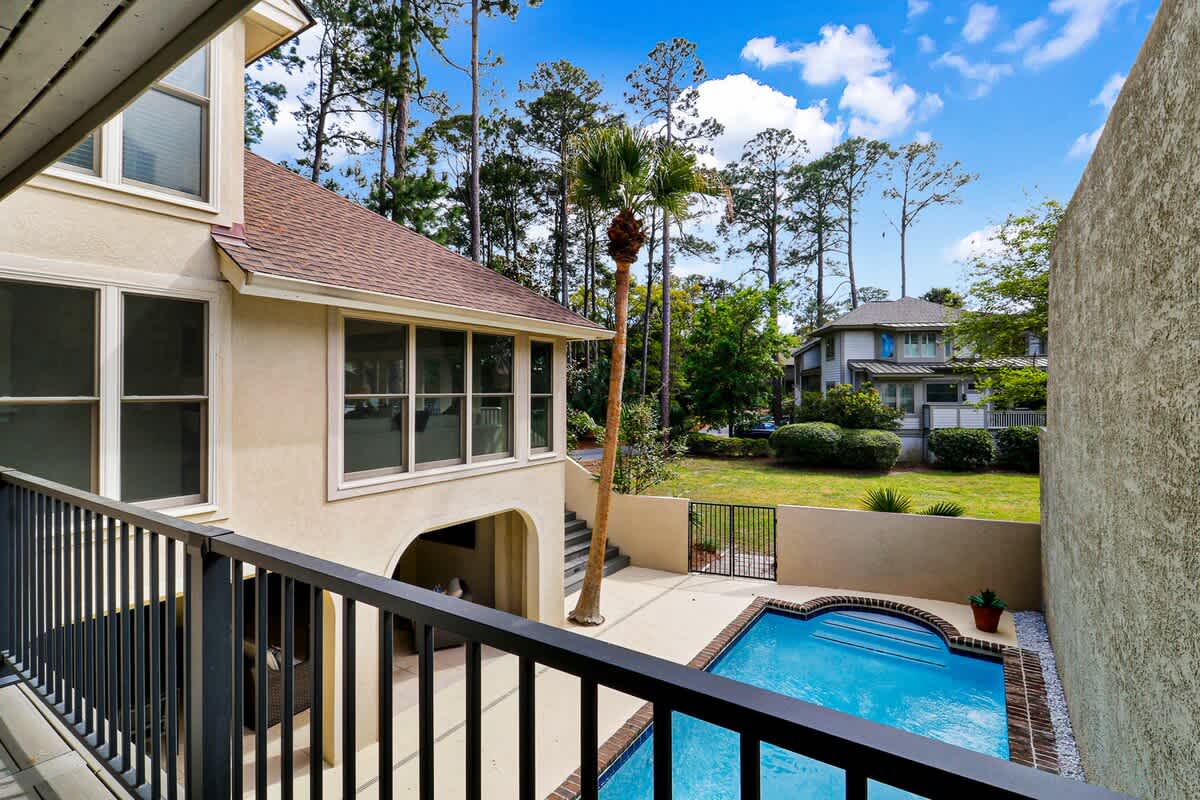 Step onto your private balcony and soak in the tranquil pool views surrounded by lush landscaping and towering trees.