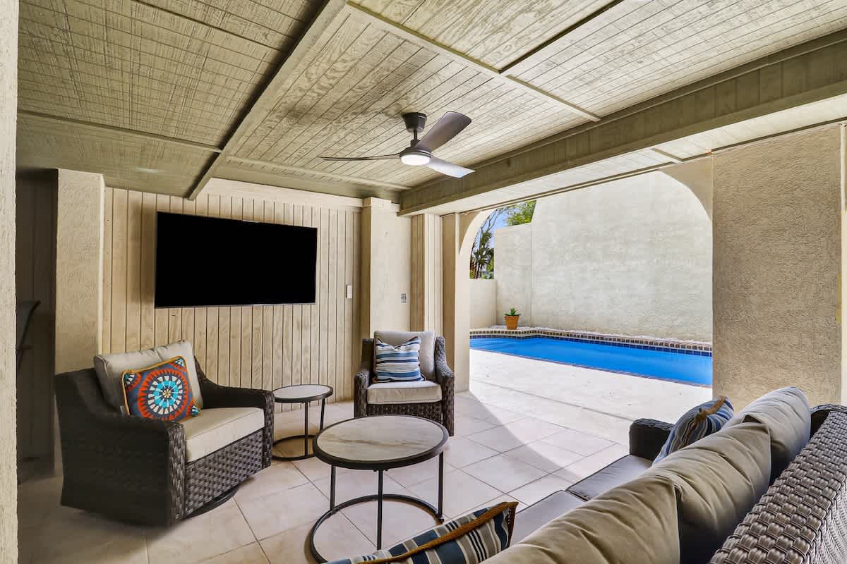 Relax in your private covered patio with pool views, plush seating, and entertainment—perfect for unwinding after desert adventures.