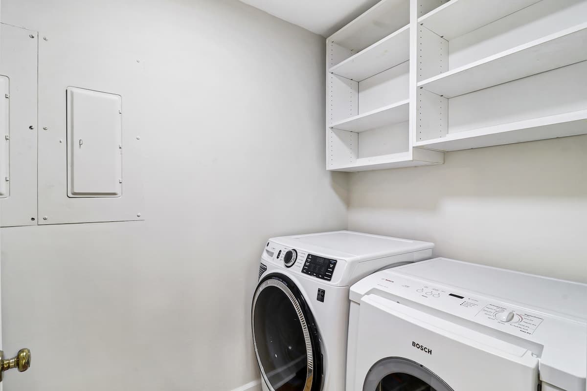 Your private laundry room keeps clothes fresh throughout your stay, with built-in shelving for storage convenience.