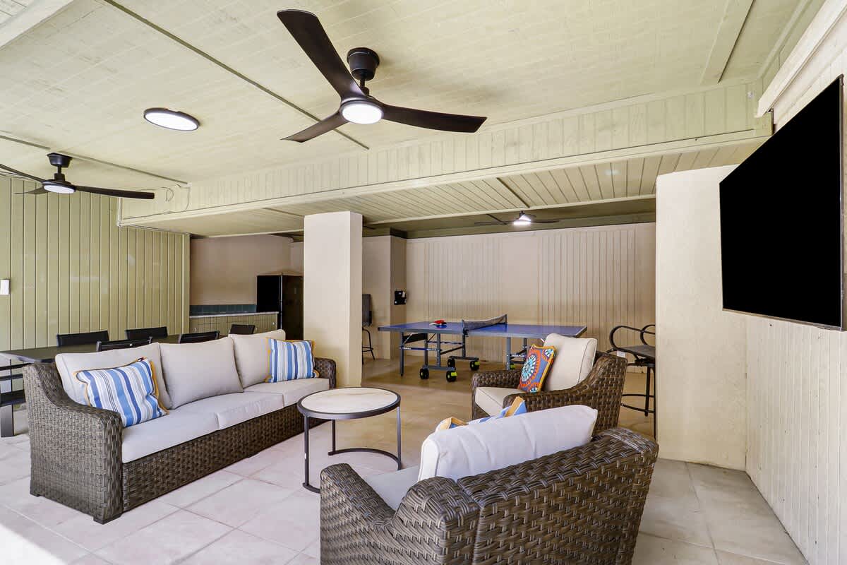 Relax in this elegant covered lounge where comfortable wicker furniture and ceiling fans create your perfect retreat for entertaining guests.