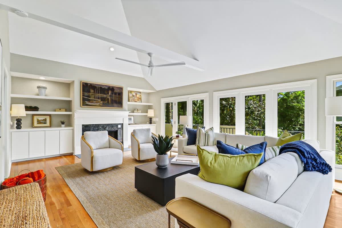 Sink into your elegant living room where natural light floods through floor-to-ceiling windows, creating the perfect space to unwind.