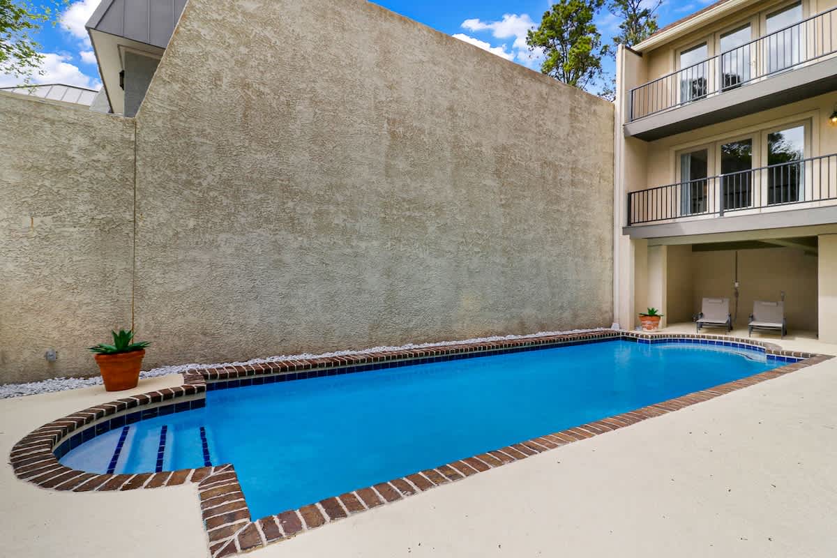 Dive into your own private oasis! This sparkling pool invites you to cool off while lounging chairs wait for your poolside relaxation.