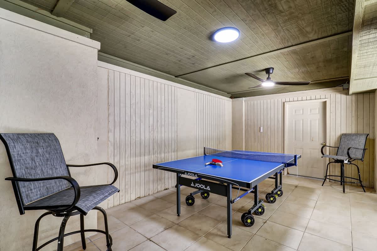 Challenge friends to exciting matches in your private game room, complete with professional table tennis setup and comfortable seating.