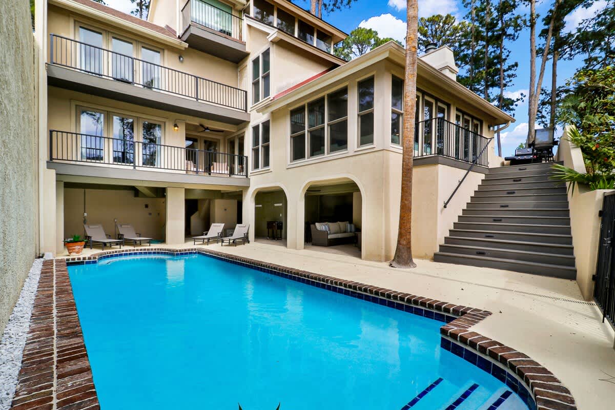 Spacious private pool area with surrounding deck and easy access to the home, designed for seamless indoor-outdoor living in the heart of Sea Pines.