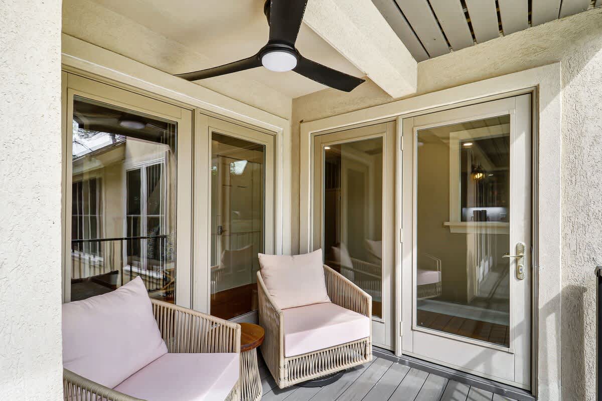 Relax on your private balcony with plush seating and overhead fan, perfect for morning coffee or evening unwinding.