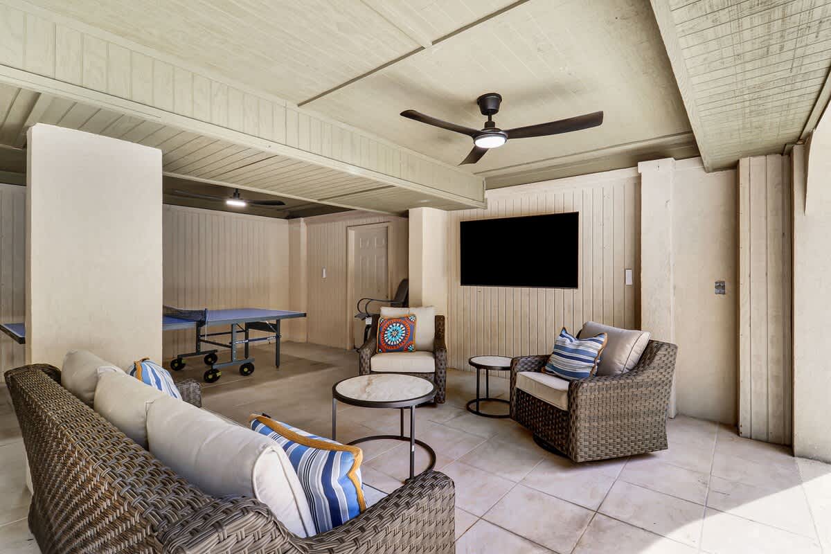 Your private game room features comfortable wicker seating and table tennis - perfect for evening entertainment after beach days.
